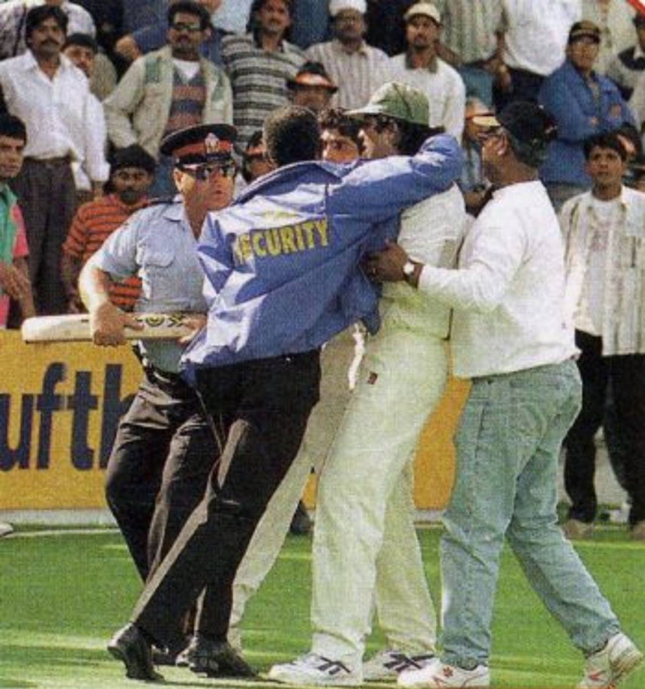 Inzamam-ul-Haq is restrained by security officials after attacking a spectator, India v Pakistan, Toronto, September 14, 1997