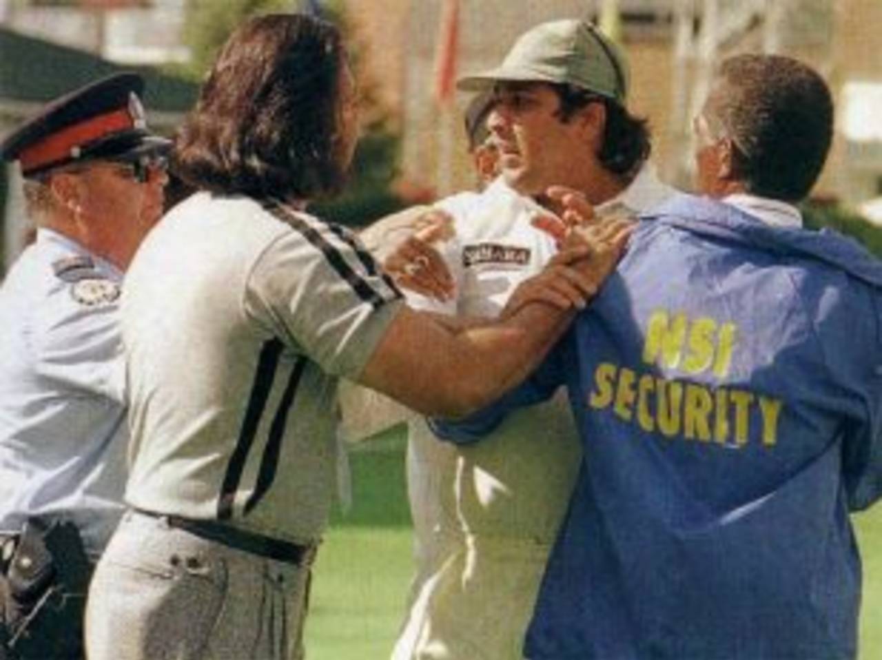 Inzamam-ul-Haq is restrained by security officials after attacking a spectator, India v Pakistan, Toronto, September 14, 1997