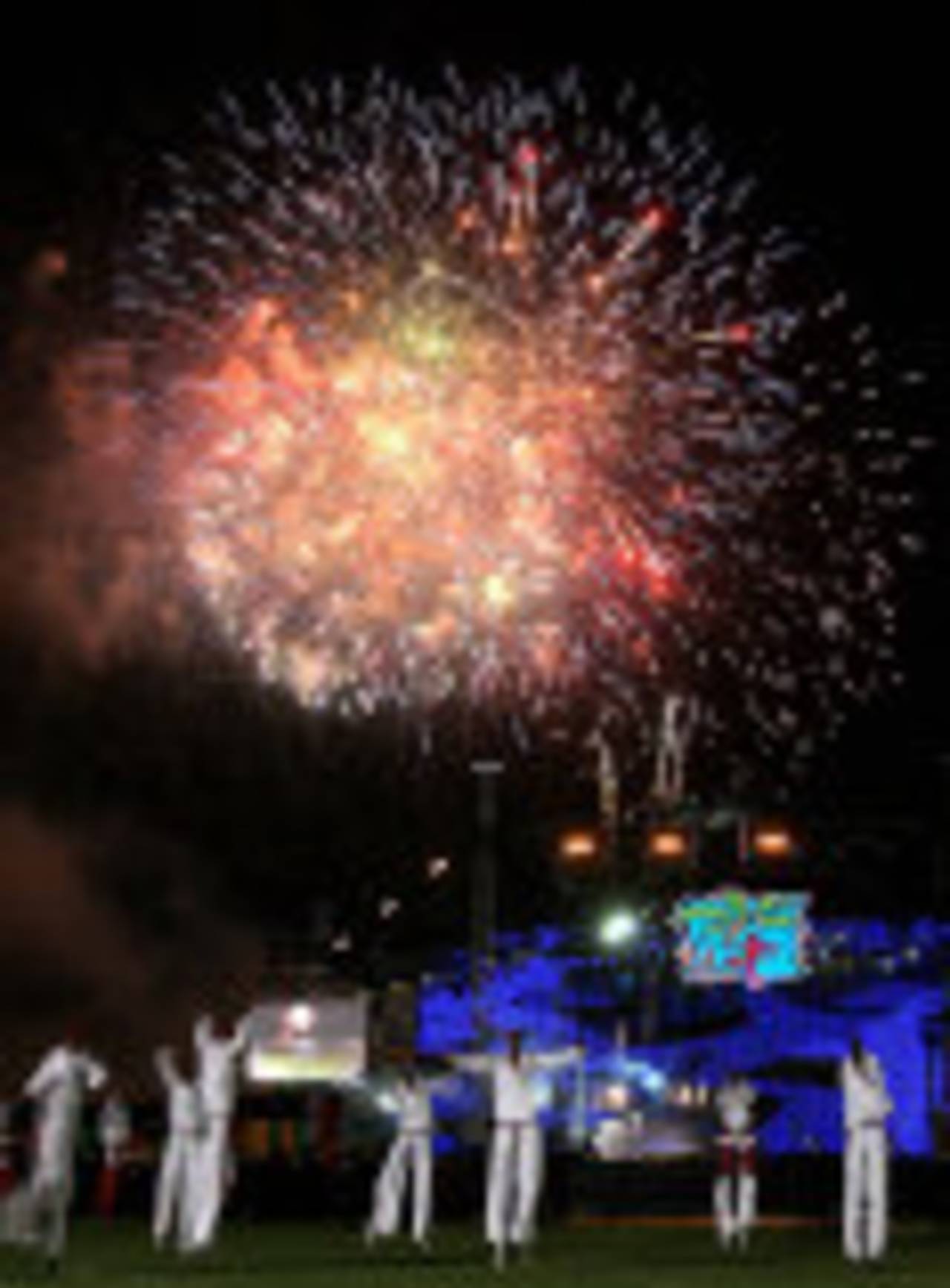 Performers dance as fireworks illuminate the night sky during the opening ceremony of the 2007 World Cup, Trelawny, March 11, 2007