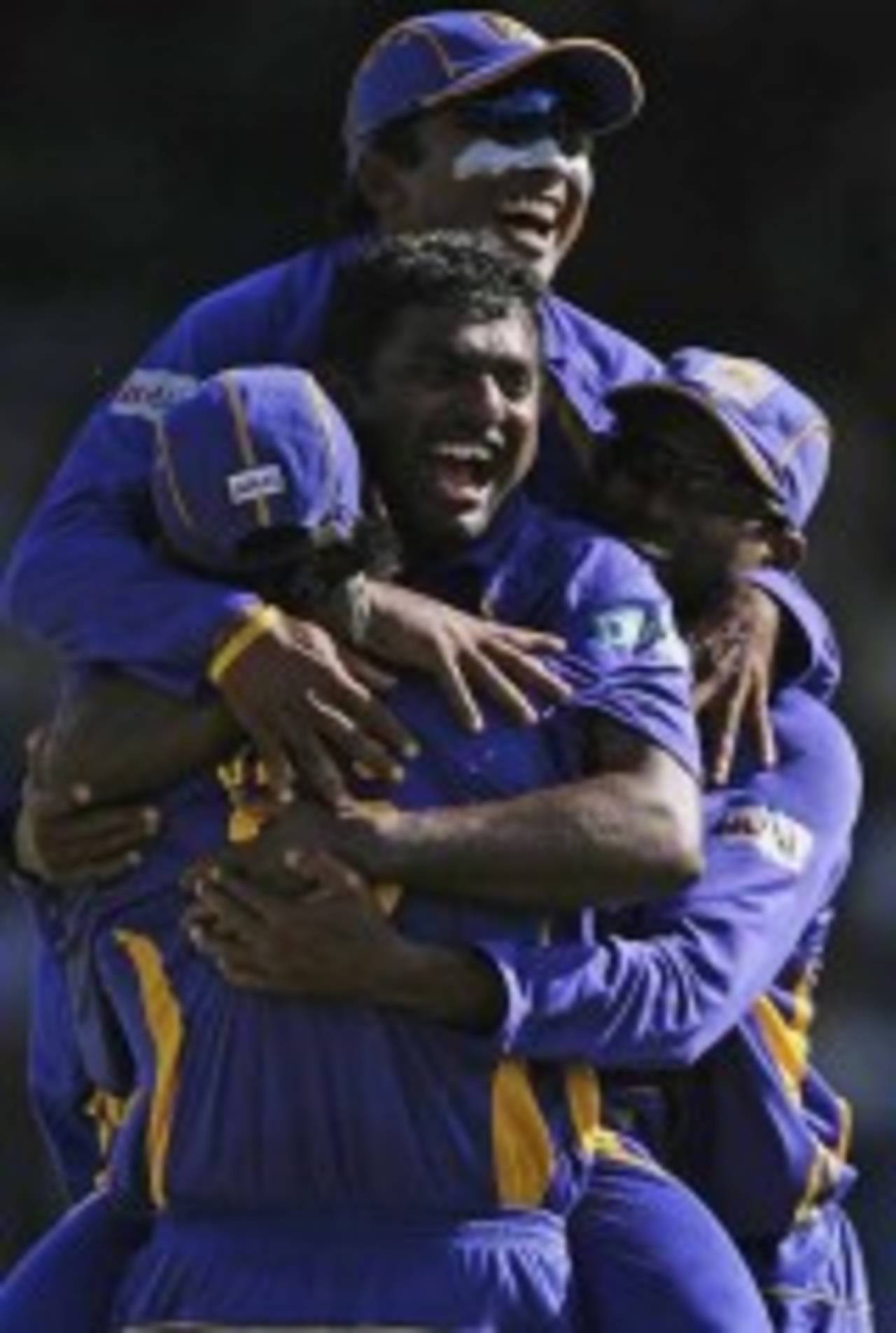 Muttiah Muralitharan is the center of attention after scalping Mahendra Singh Dhoni, India v Sri Lanka, Group B, Trinidad, March 23, 2007