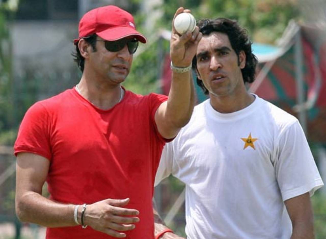 Wasim Akram explains the finer points of fast bowling to Umar Gul during a net session in Lahore, May 13, 2007