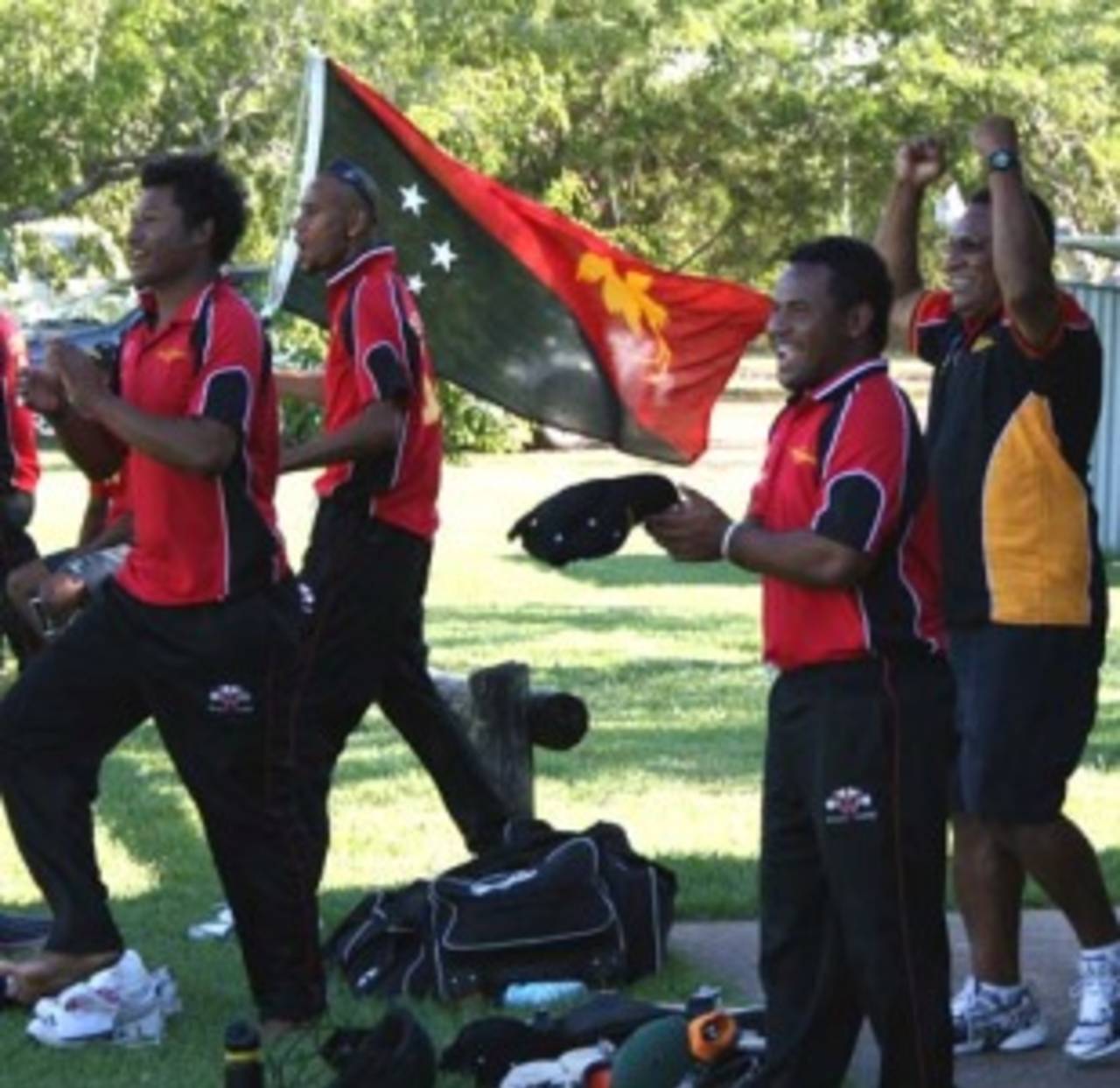 PNG players Assad Vala, Inoa Baeau, Mahuru Dai and coach Api Leka celebrate their victory over Italy, PNG v Italy, Darwin, May 20, 2007