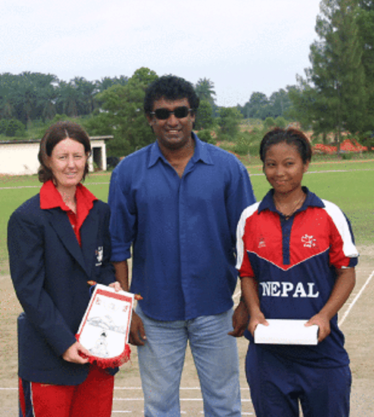 Hong Kong captain Neisha Pratt and Nepal captain Nary Thapa pose for pictures along with match referee Rumesh Ratnayake, Hong Kong women v Nepal women, ACC women's tournament, Johor, July 15, 2007