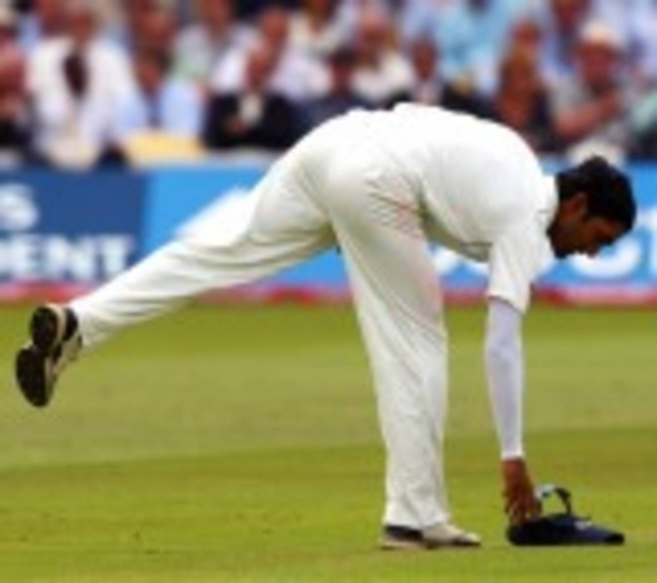 Dinesh Karthik retrieves his cap after dropping a catch off Andrew Strauss, England v India, 1st Test, Lord's, 1st day, July 19, 2007