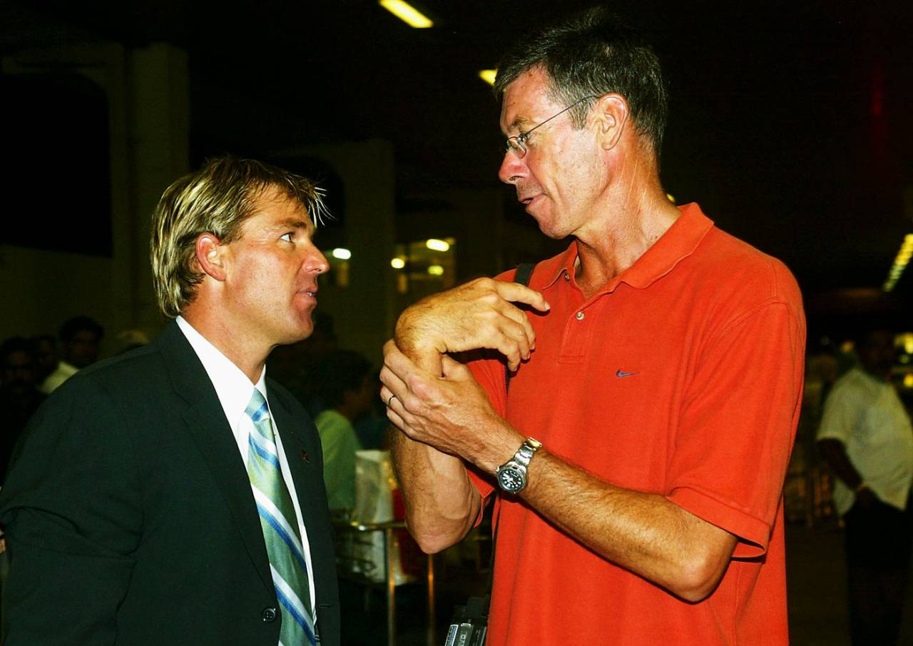Shane Warne and John Buchanan chat after the Australian squad arrived at Colombo airport February 28, 2004