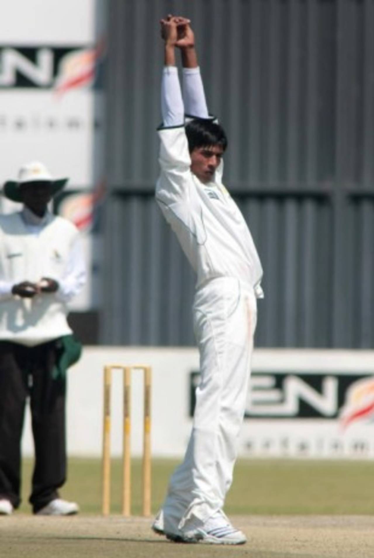 Mohammad Aamer stretches after completing an over, Zimbabwe Board XI v Pakistan National Cricket Academy, third day, Harare, August 25, 2008

