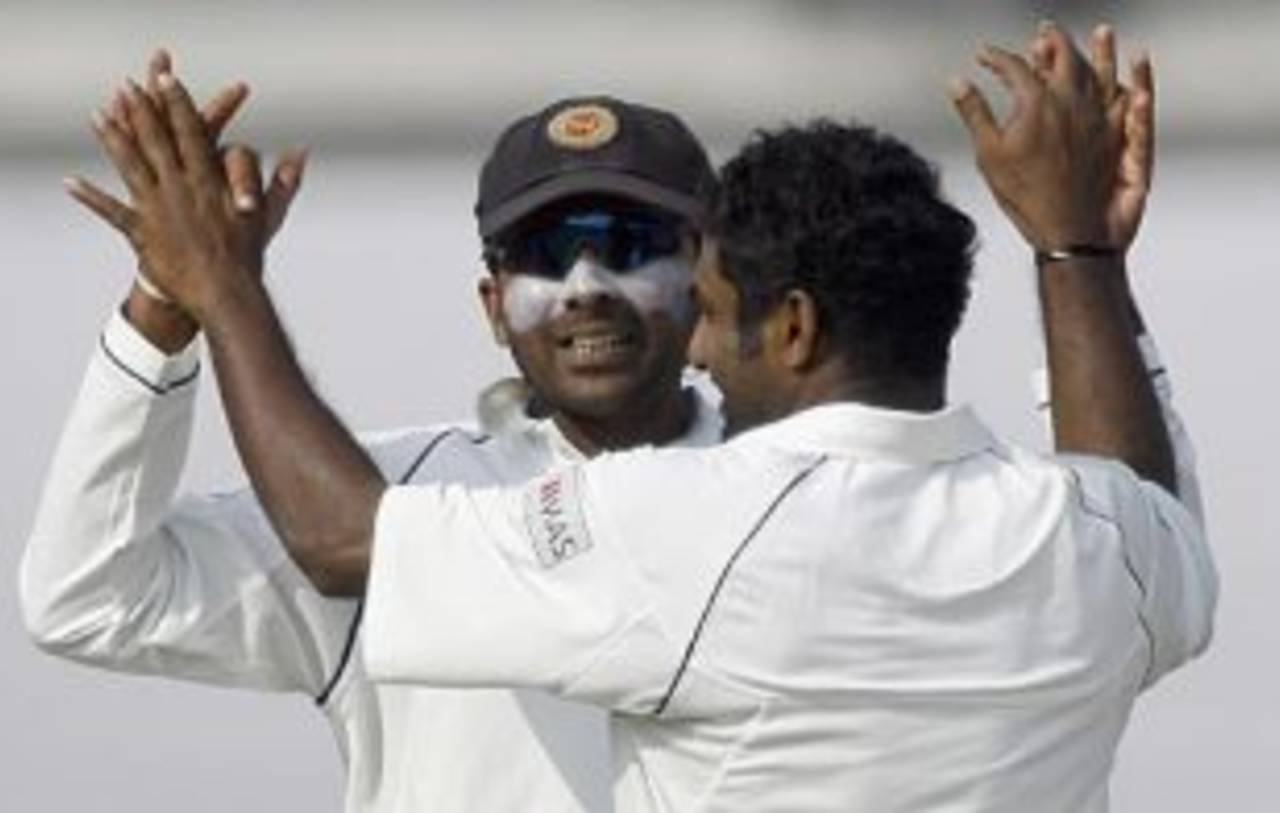 Muttiah Muralitharan is congratulated by Mahela Jayawardene after dismissing Junaid Siddique, Bangladesh v Sri Lanka, 1st Test, Dhaka, 4th day, December 30, 2008