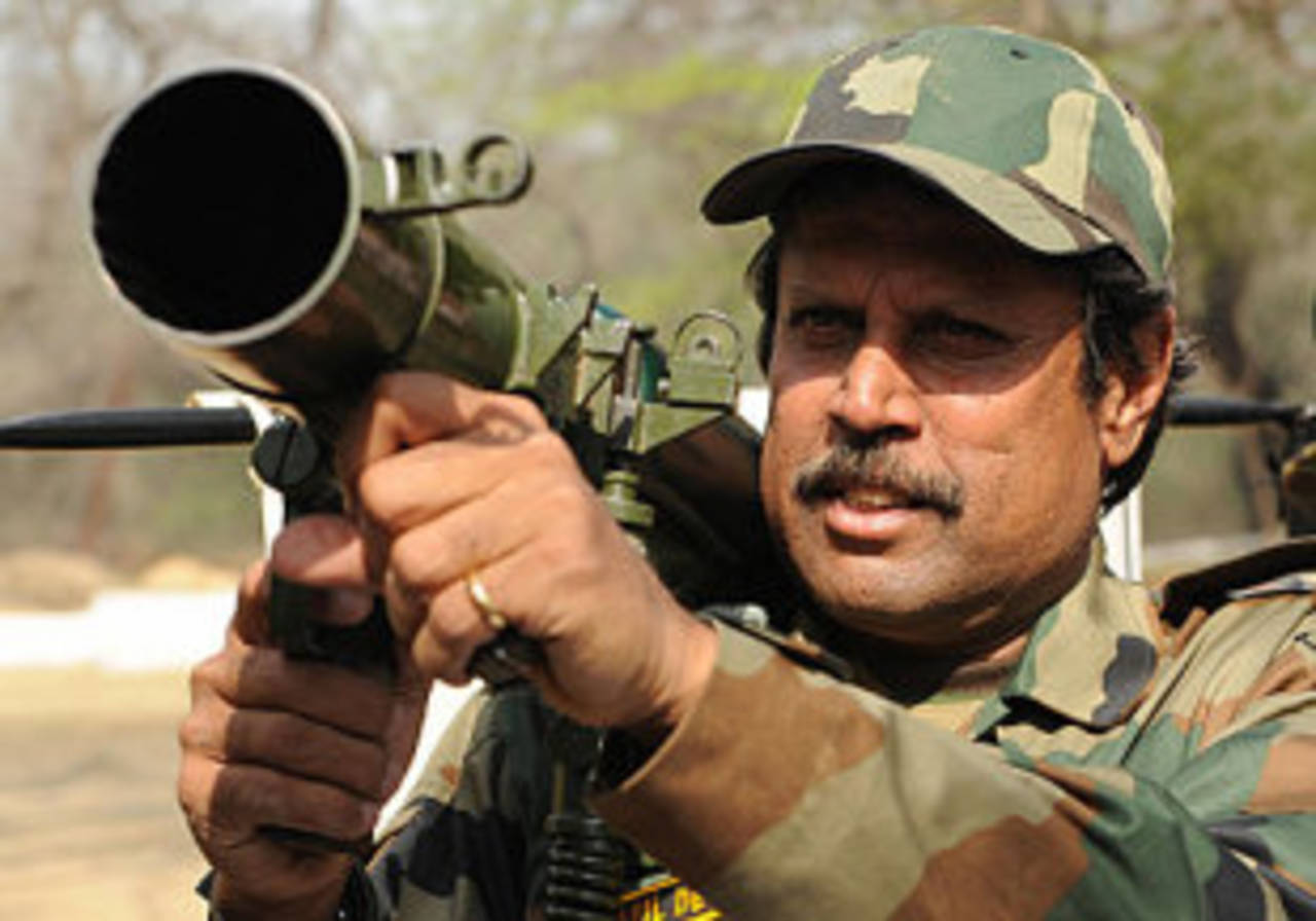 Kapil Dev holds a mortar during an introductory military training course, New Delhi, February 20, 2009