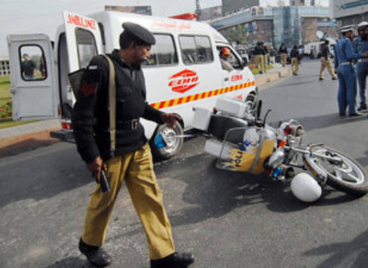 A policeman inspects a police motorcycle after the terrorist attack, Lahore, March 3, 2009