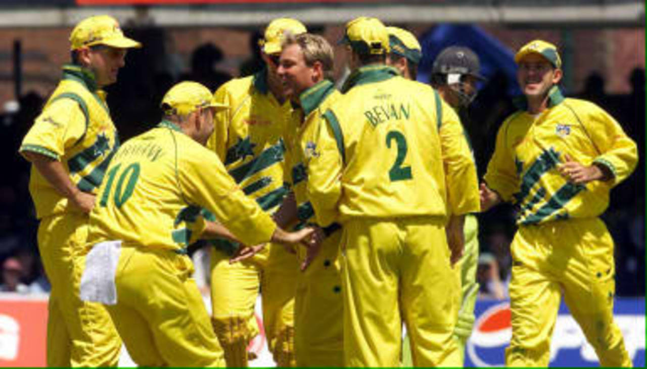 Australia's Shane Warne is congratulated by teammates after taking the wicket of Ijaz Ahmed 20 June 1999 during the cricket World Cup final at Lord's