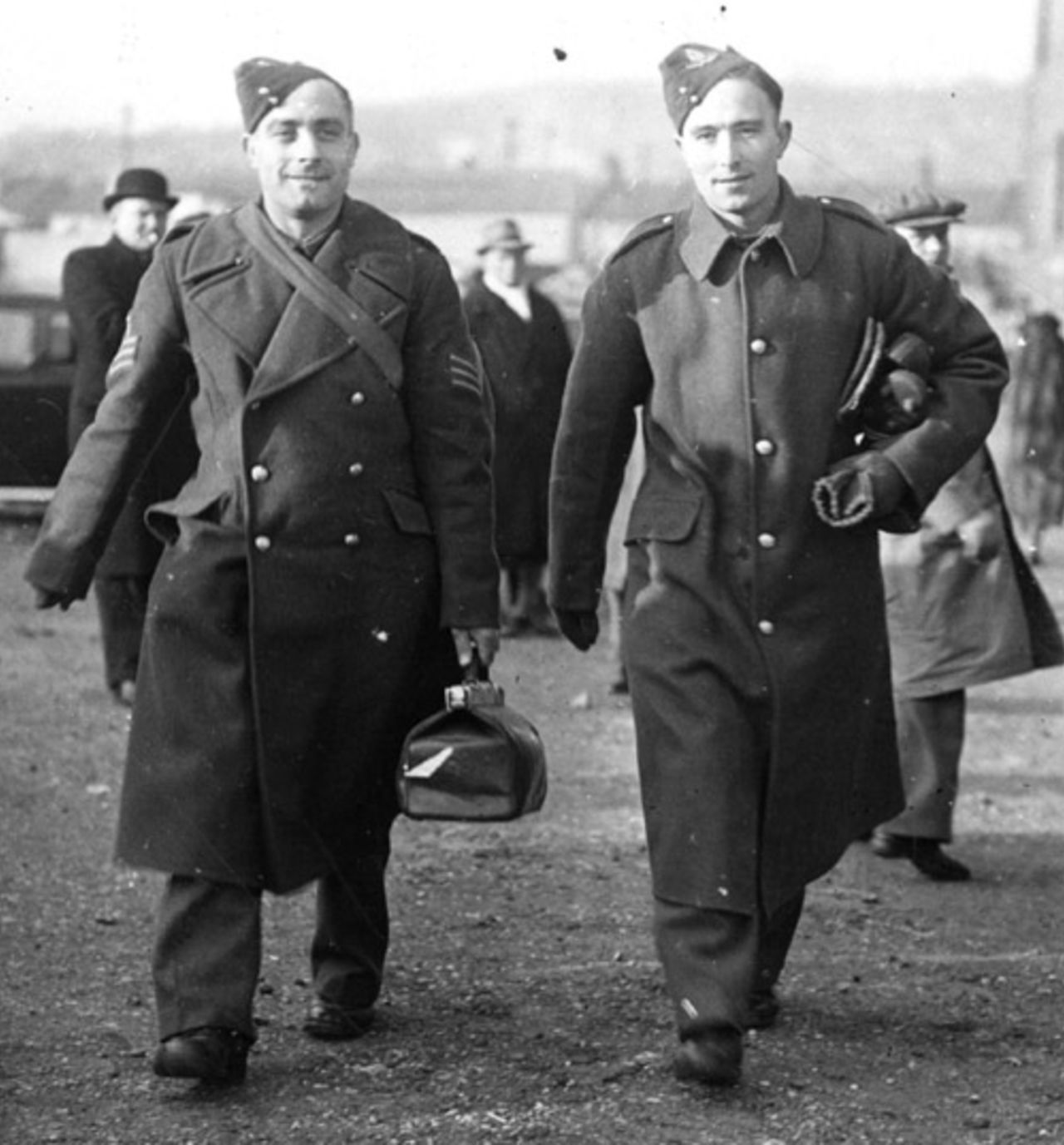 England and Arsenal footballers Sergeant Wilf Copping, left, and Gunner Denis Compton arrive in uniform at Selhurst Park to play for the Army team against the Football Association