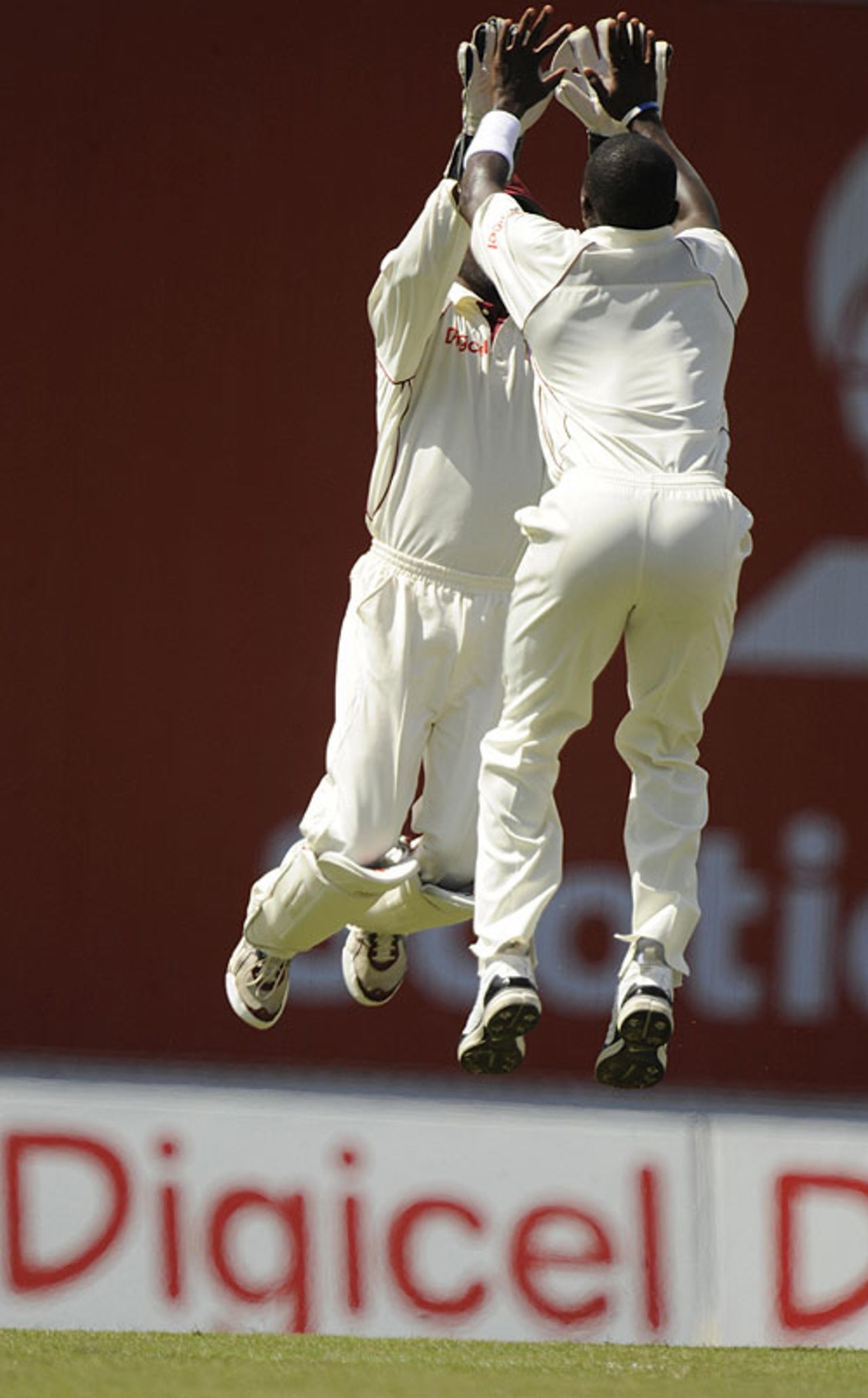 Fidel Edwards and Denesh Ramdin levitate after the dismissal of Andrew Strauss, West Indies v England, 5th Test, Trinidad, March 7, 2009