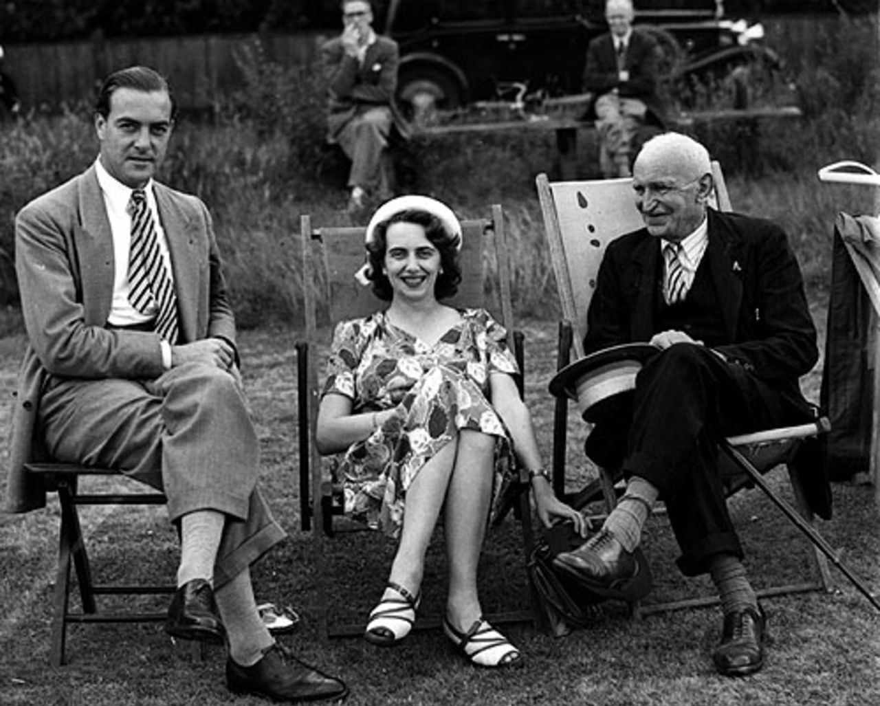 Princess Katherine of Greece and Denmark and her husband Major Richard Brandram (left) chat with Louis Weigall while watching the game, Kent v Surrey, County Championship, 1st day, July 19, 1947 