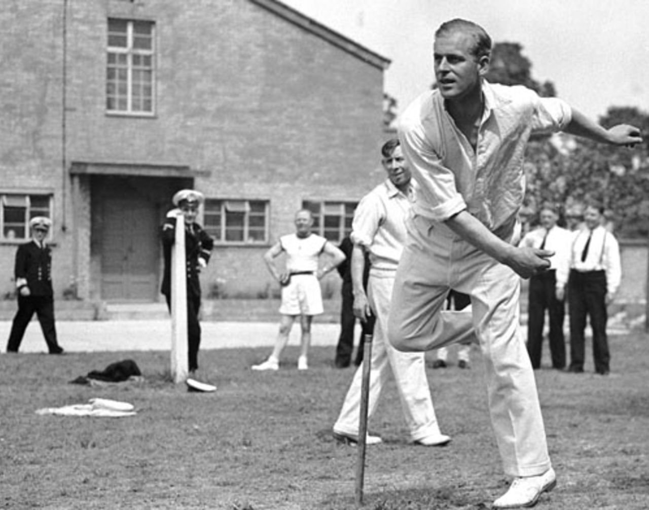 Lieutenant Philip Mountbatten takes a turn at bowling while off duty at the Petty Officers' Training Centre in Corsham, Wiltshire, August 1, 1947