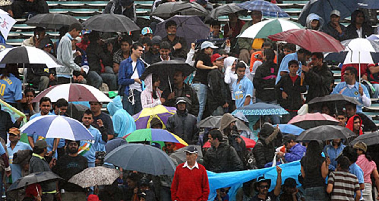 Indian supporters take cover from the rain at Eden Park, New Zealand v India, 5th ODI, Auckland, March 14, 2009