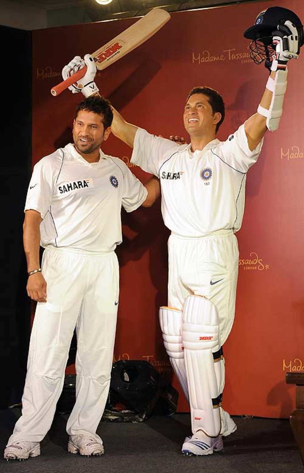 Sachin Tendulkar stands next to his wax figure in Mumbai, April 13, 2009