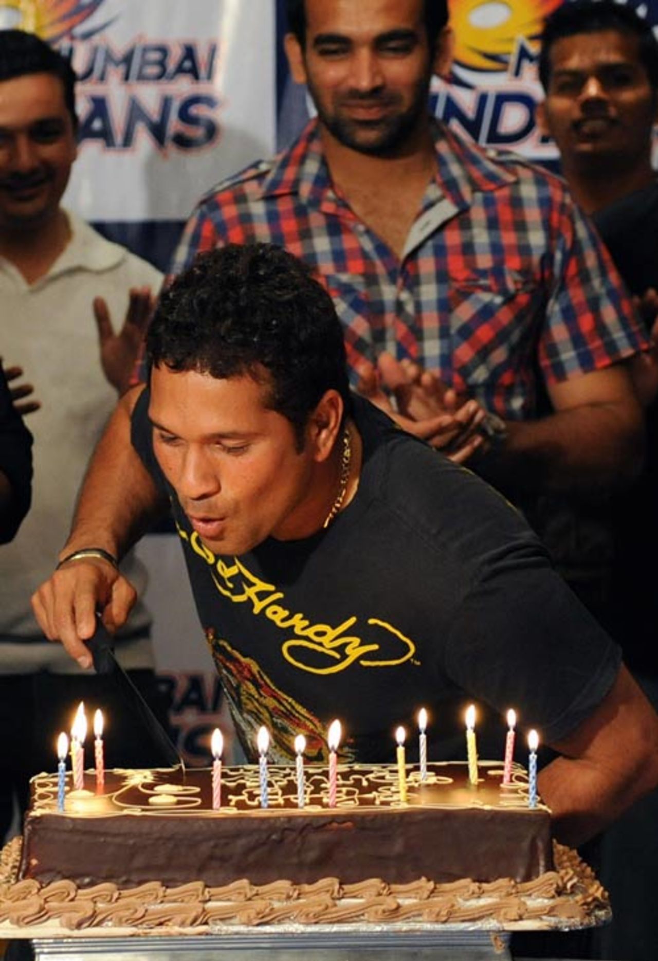 Zaheer Khan watches as Sachin Tendulkar blows out the candles on a cake at a surprise birthday party, Durban, April 24, 2009