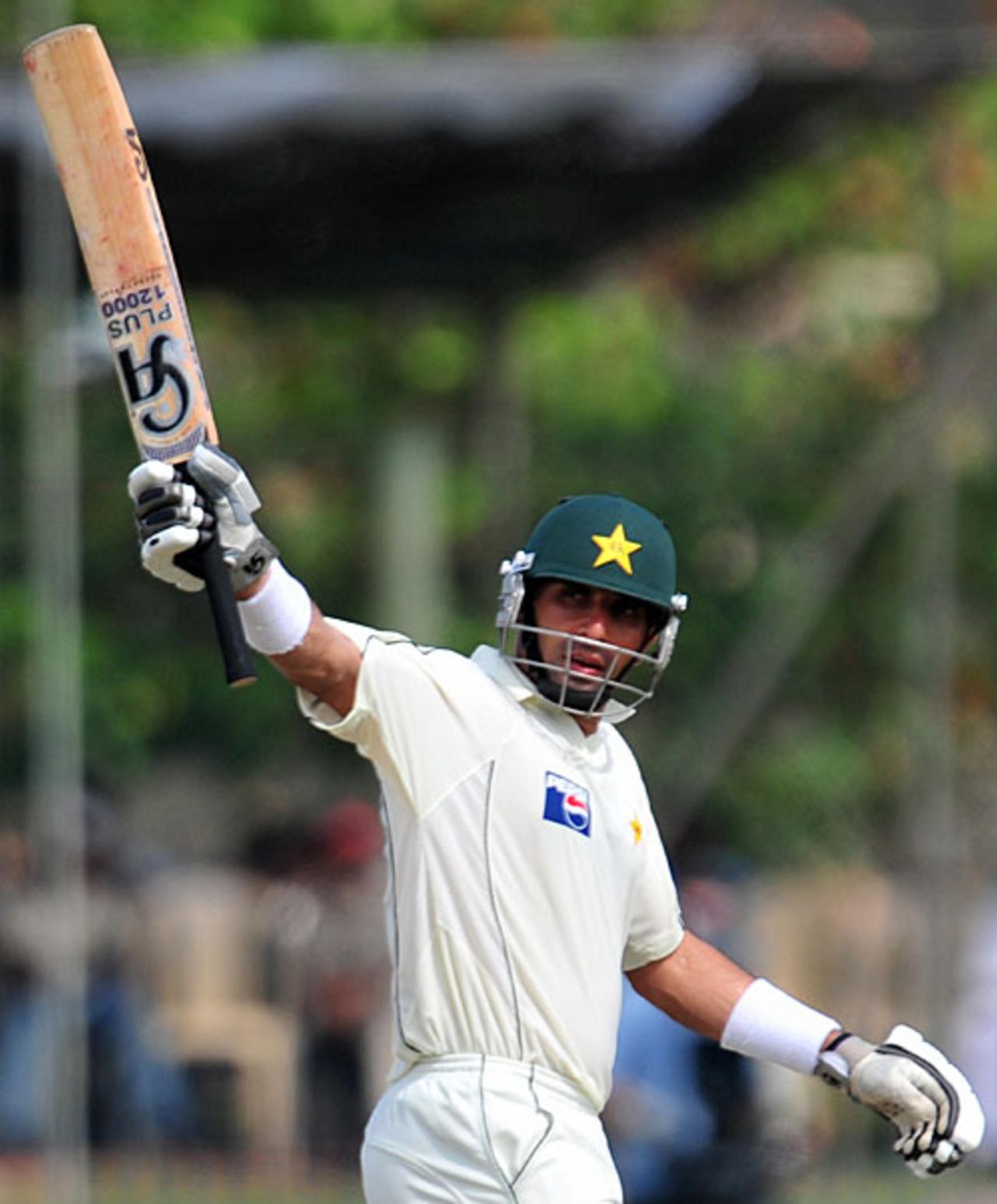 Misbah-ul-Haq raises the bat after reaching his half-century, Pakistan v Sri Lanka, 1st Test, Galle, 2nd day, July 5, 2009