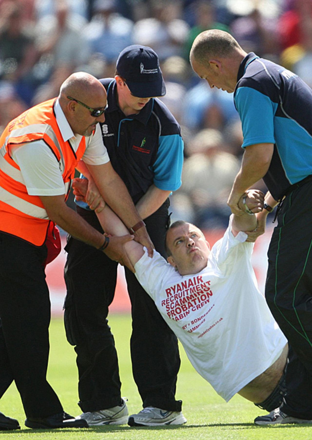 A man protesting against the recruitment policies of an airline is dragged off the Cardiff pitch, England v Australia, 1st Test, Cardiff, 5th day, July 12, 2009