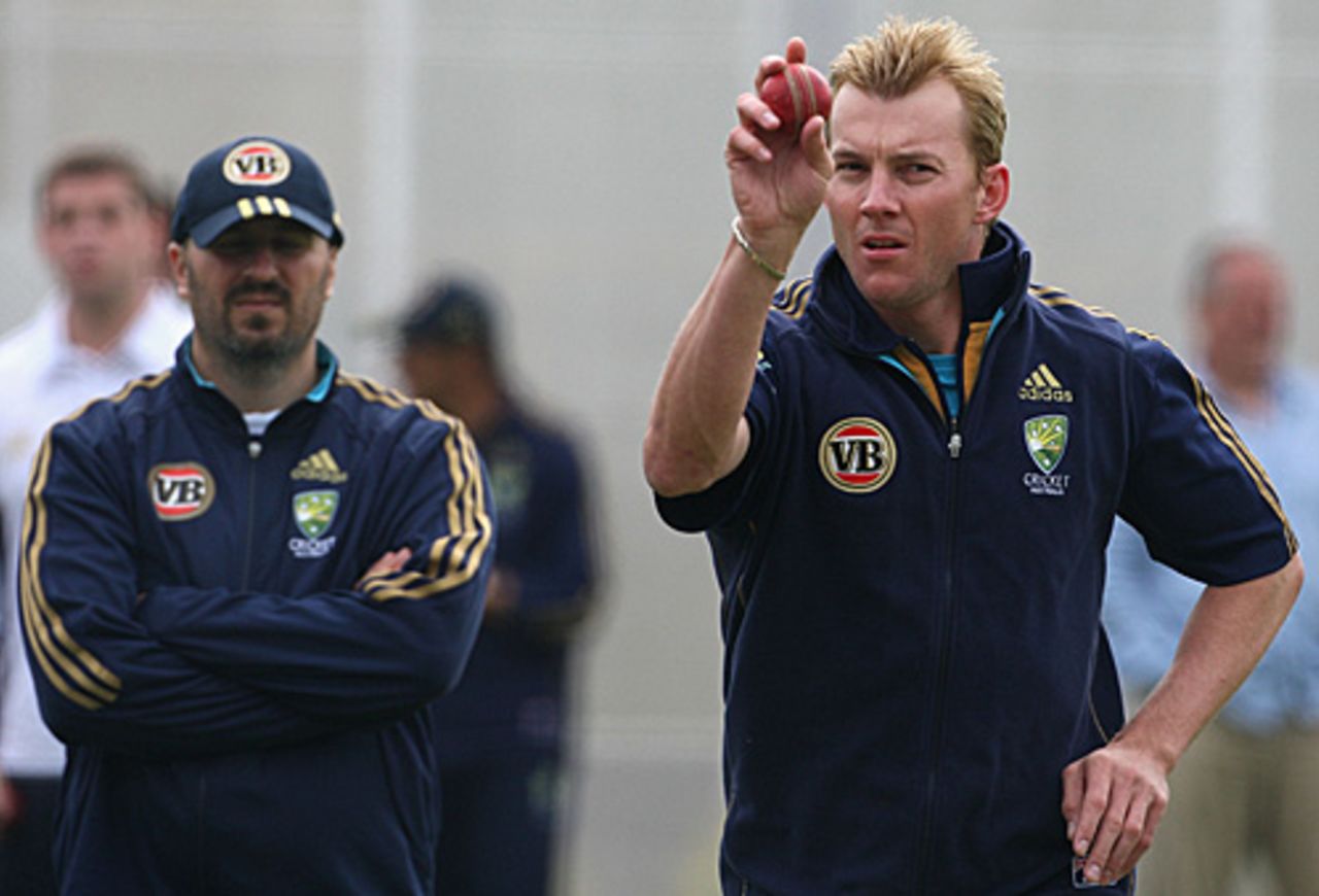 The Australia physio, Alex Kontouris, keeps a careful eye on Brett Lee during a net session, Edgbaston, July 28, 2009