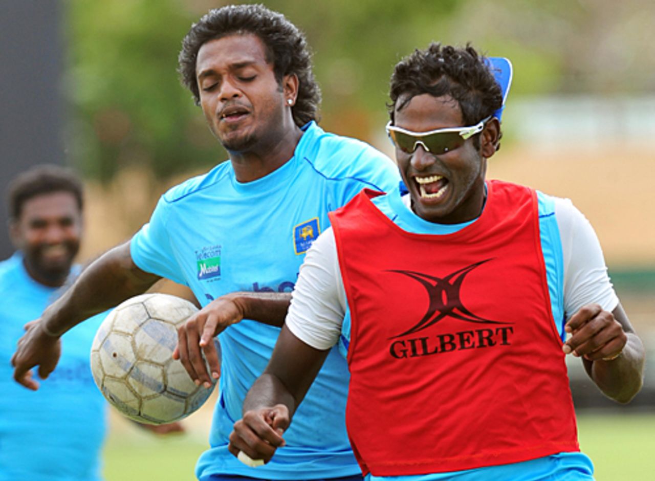 Angelo Mathews and Dilhara Fernando jostle for possession during a game of football, Dambulla, July 29, 2009