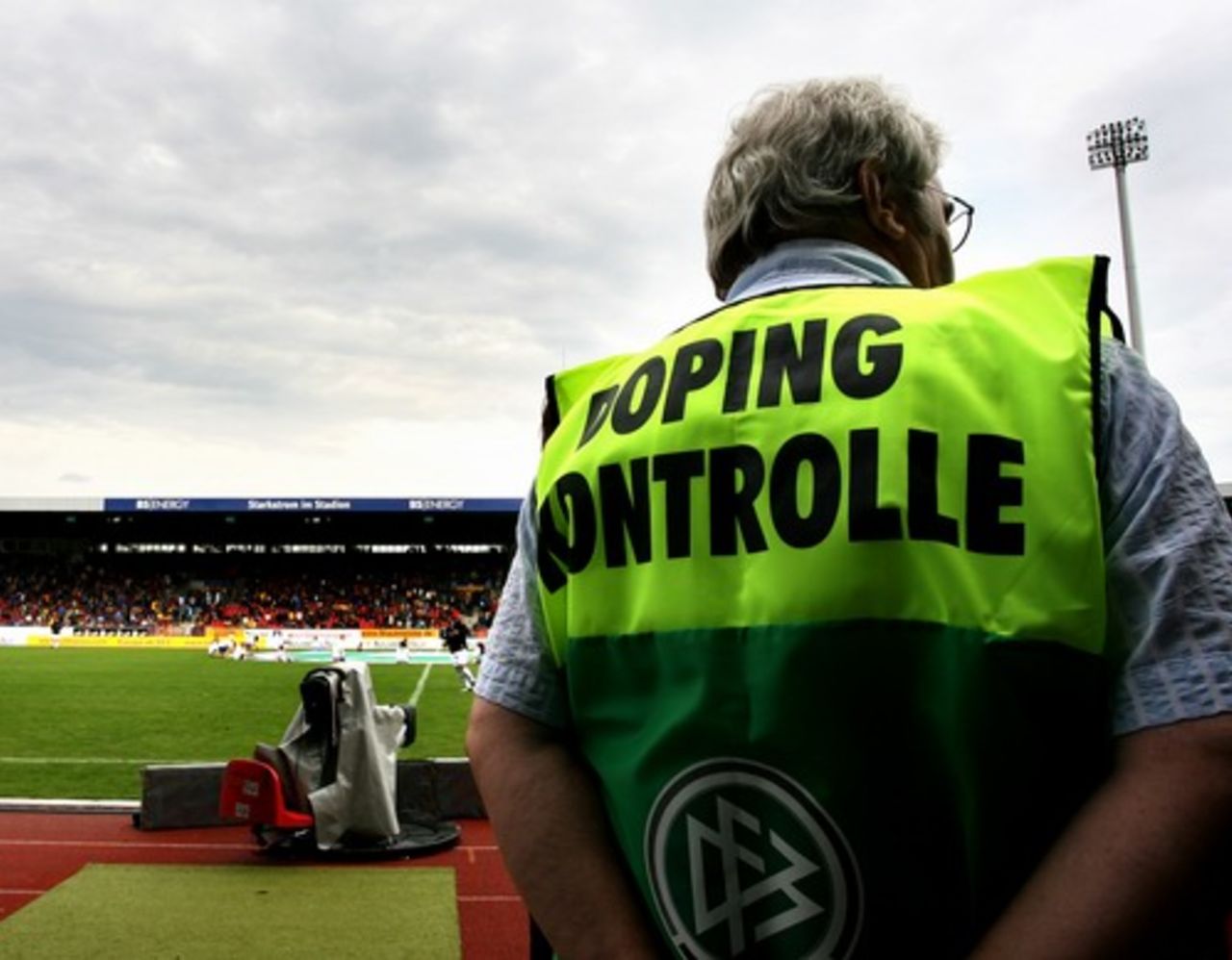 An anti-doping inspector stands next to the pitch during the 3. Liga match between Eintracht Braunschweig and VfL Osnabrueck, Braunschweig, Germany, July 25, 2009