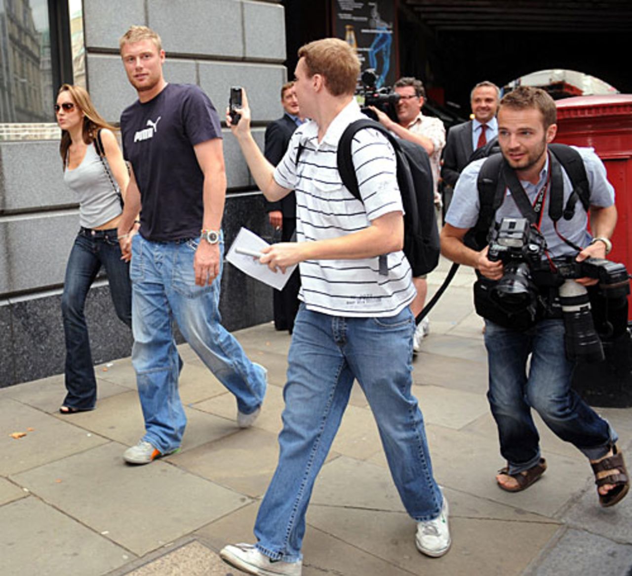 Andrew Flintoff and wife Rachael are followed by press persons and fans, London, August 24, 2009