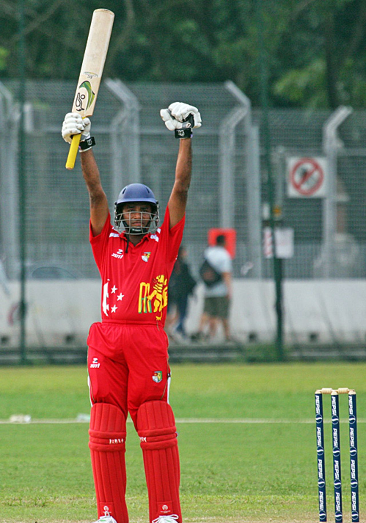 Buddikha Mendis raises his bat to salute his match-winning century against Bahrain, Singapore v Bahrain, ICC World Cricket League Division 6, Singapore, September 1, 2009