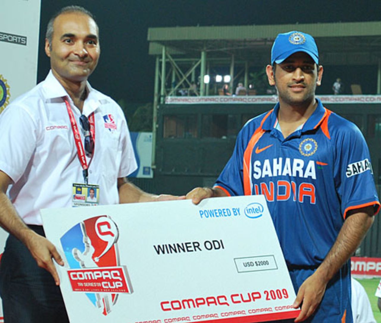 MS Dhoni is presented with the winning team's cheque, India v New Zealand, 2nd match, Compaq Cup, Colombo, September 11, 2009