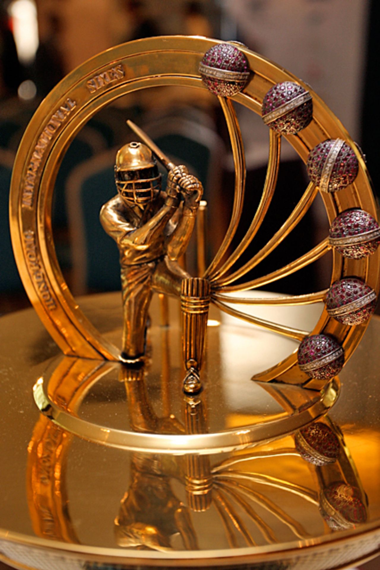 A golden batsman and six jewel encrusted cricket balls adorn the top of the Butani Cup