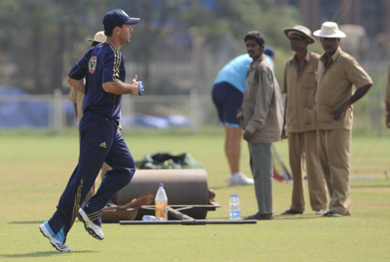 Ricky Ponting runs as ground staff look on during a practice session, Mumbai, October 23, 2009