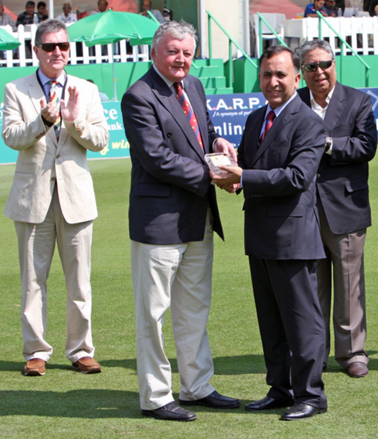 ICC President David Morgan is presented with a gift by HKCA President Capt. Saleem. Also in the picture are HKCA Hon. Secretary John Cribbin and HKCA Hon. Life Member Papu Butani