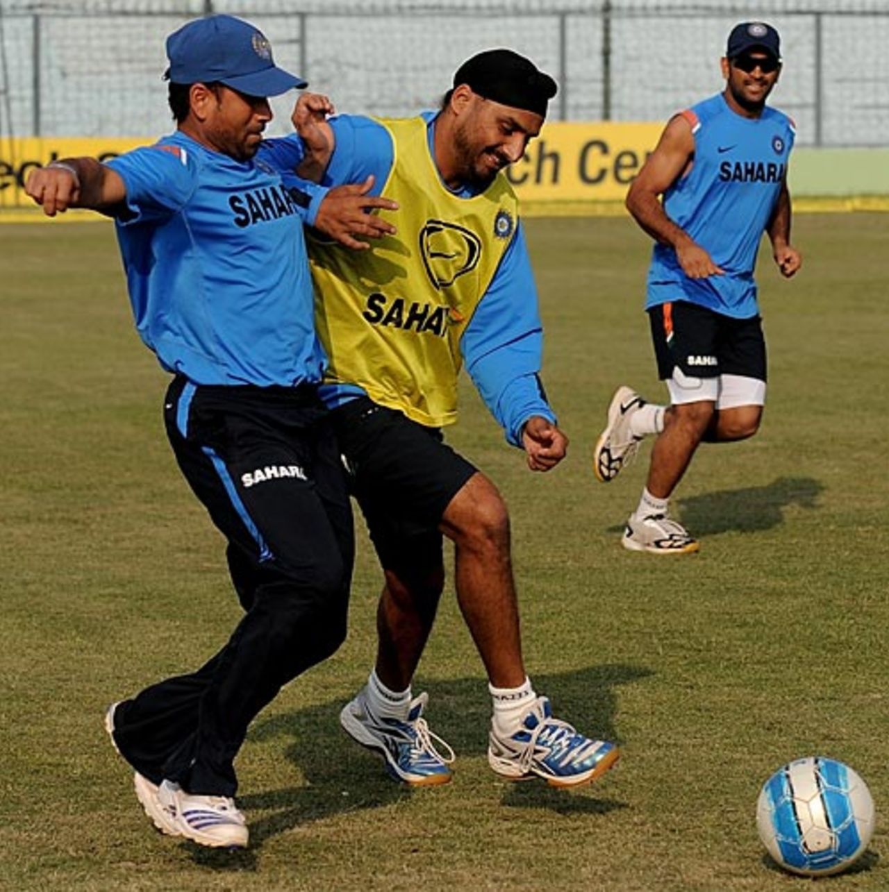 Harbhajan Singh and Sachin Tendulkar jostle for the football, Kanpur, November 22, 2009