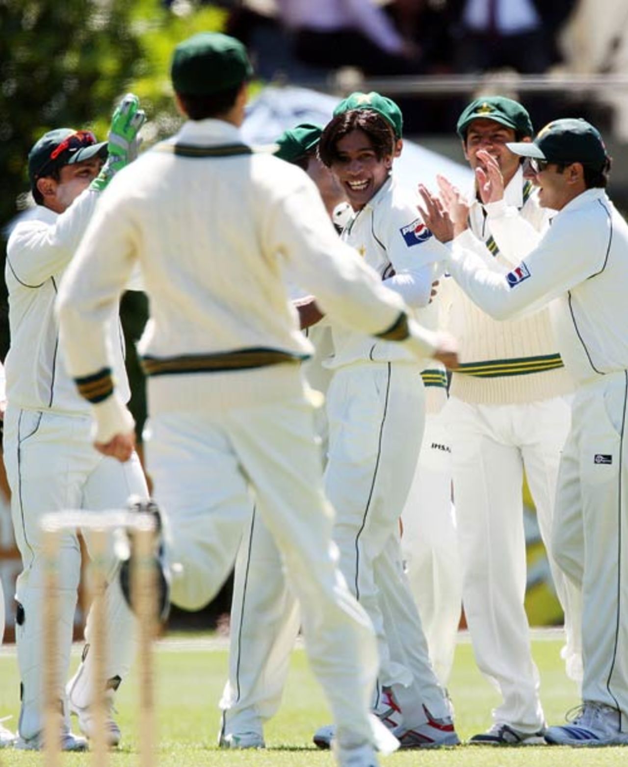 Mohammad Aamer is mobbed by his team-mates after striking with the first ball of the match, New Zealand v Pakistan, 1st Test, Dunedin, 1st day, November 24, 2009