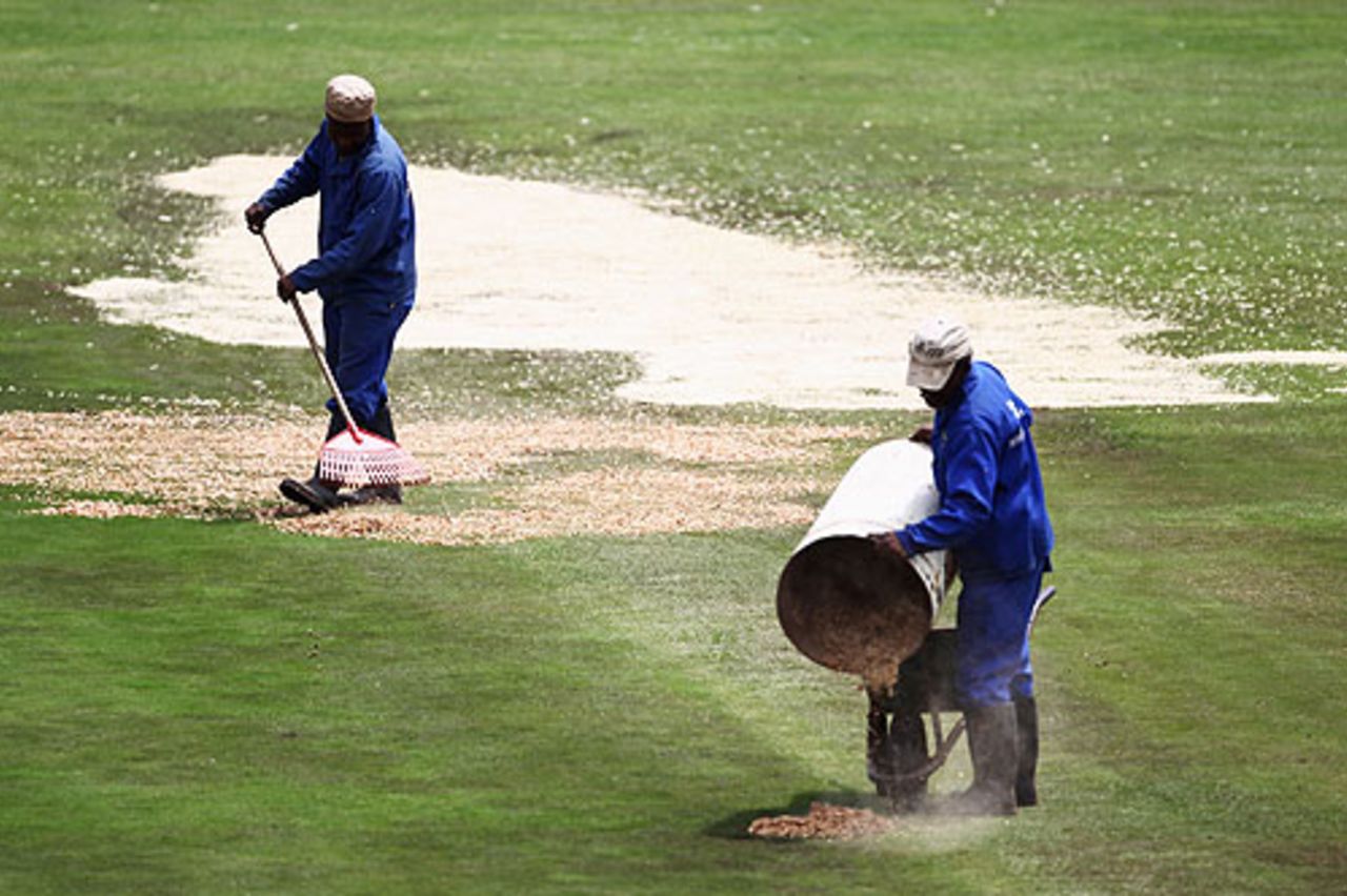 The Buffalo Park groundstaff cover the damp outfield in sawdust, South African Invitational XI v England XI at East London, December 10, 2009 