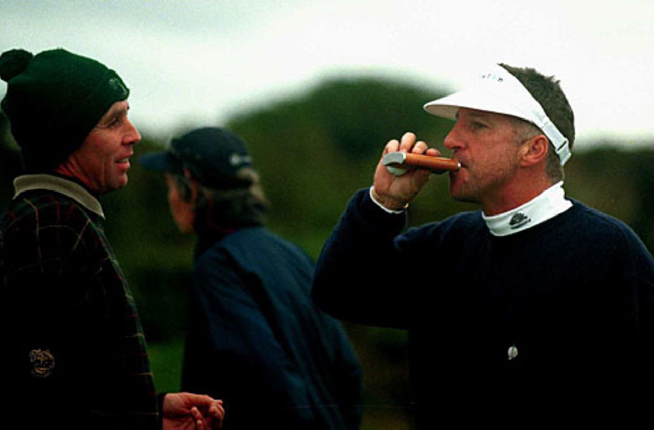 Ian Botham takes a sip from his hip flask as tennis player Ivan Lendl looks on ahead of the Alfred Dunhill Cup, Scotland, October 10, 2000
