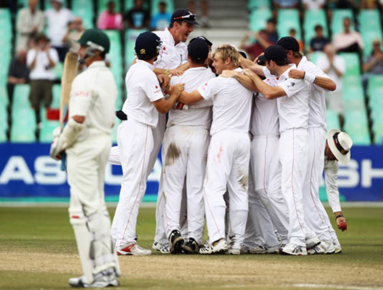 Graeme Swann took the final wicket to fall, as he did at the Oval to secure the 2009 Ashes, and was mobbed by his team-mates as Dale Steyn looks on, South Africa v England, 2nd Test, Durban, December 30, 2009 