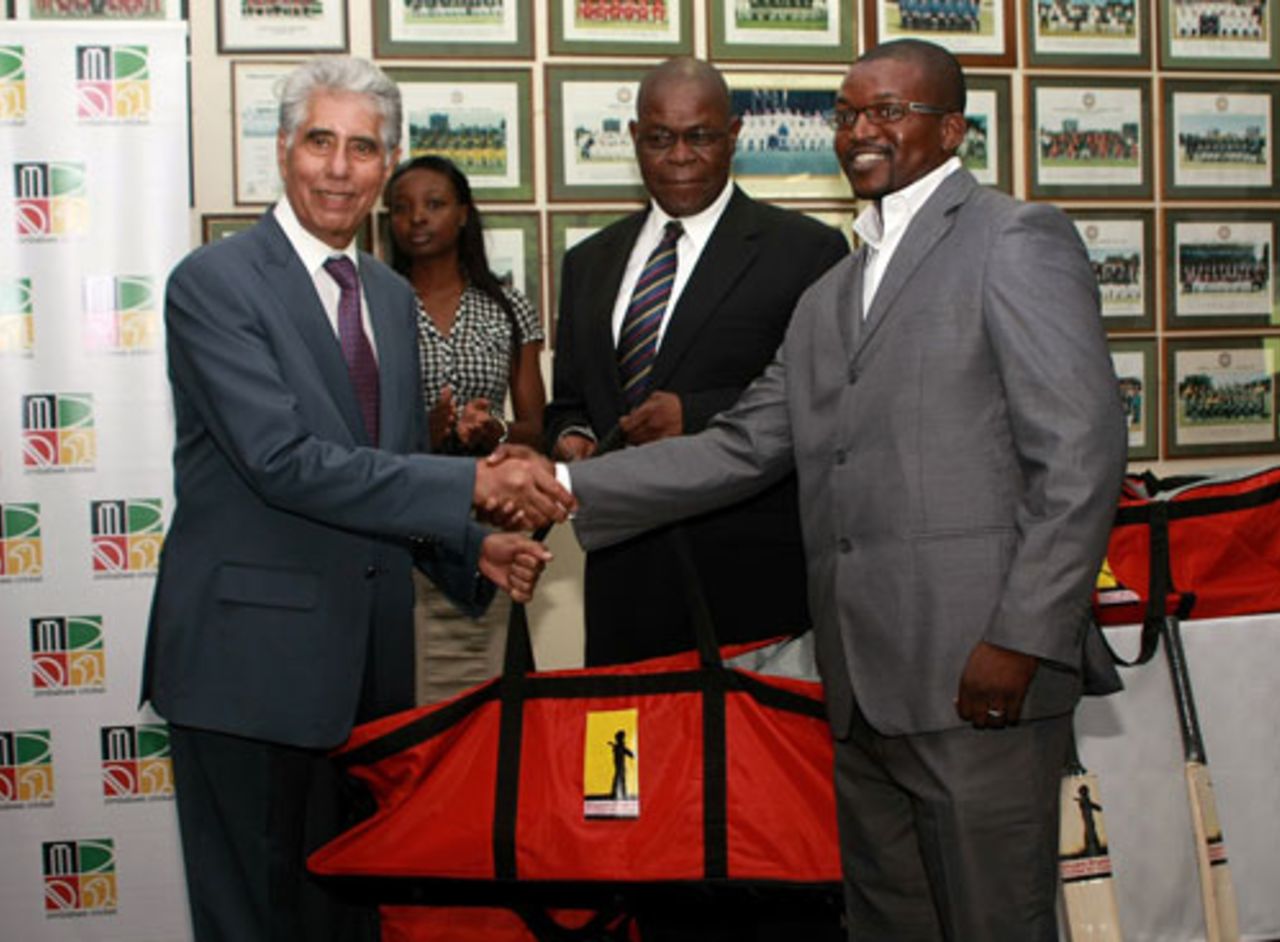 Mashonaland Eagles CEO, Hugo Ribatika accepts one of the kit bags from Shyam Bhatia while ZC Board Chairman Peter Chingoka looks on, 28 January, 2010
