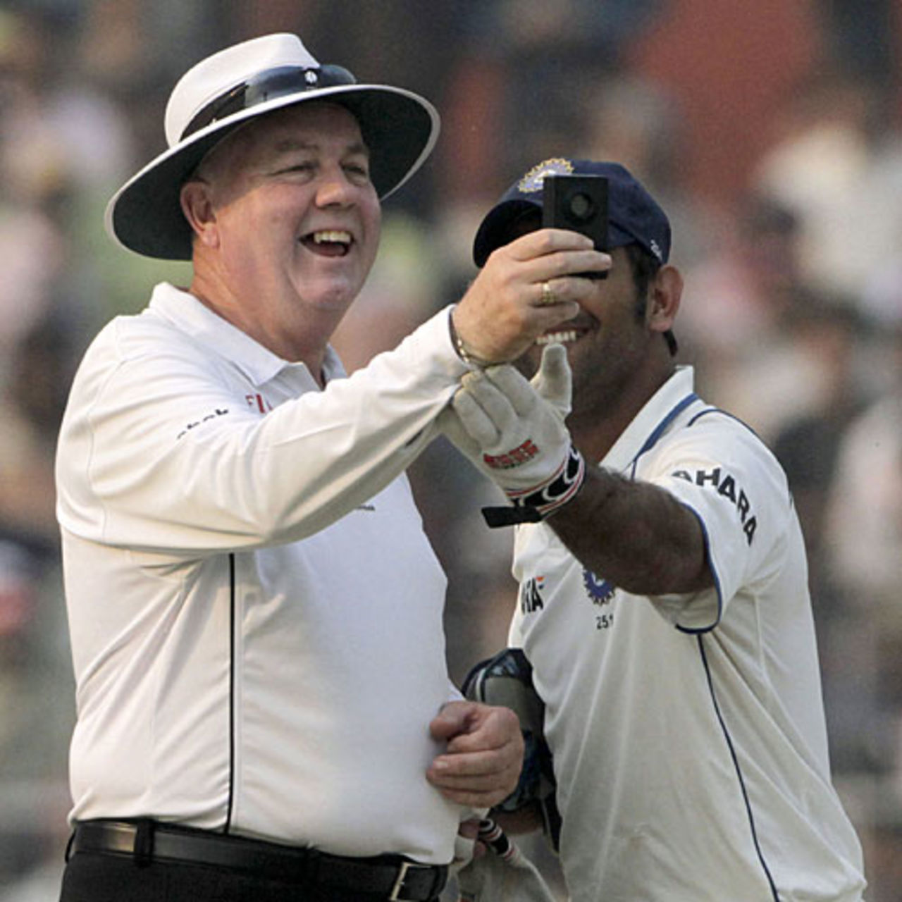 Steve Davis has a laugh while checking the light meter with MS Dhoni, India v South Africa, 2nd Test, Kolkata, 3rd day, February 16, 2010