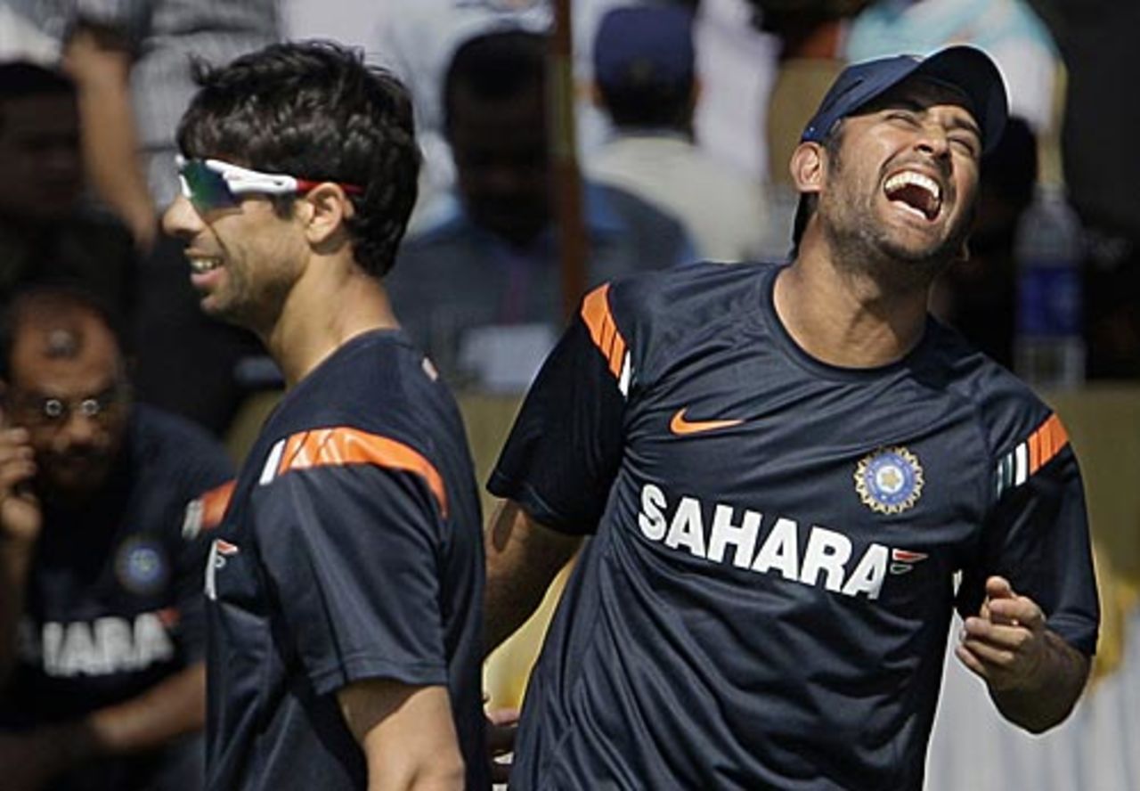 Ashish Nehra and MS Dhoni share a joke during a training session, Jaipur, February 20