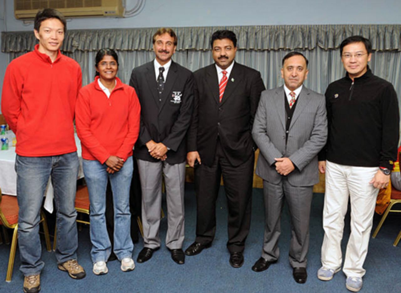 China Women's Cricket Team officials Mamatha Maben (Coach) and Ge Tao (Coach) pose for a photo with Hong Kong's Afzaal Haider, Alex Ilyas, Capt Saleem and  Danny Lai