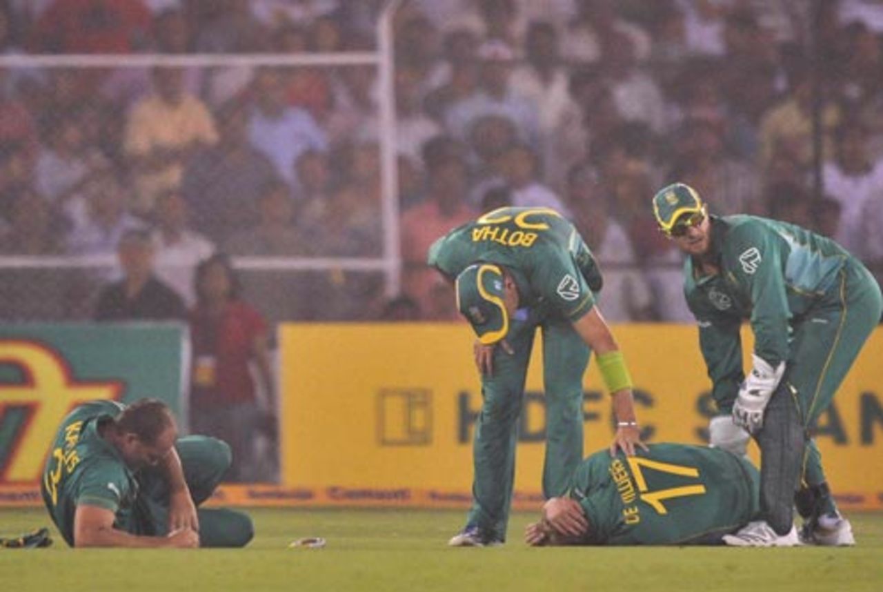 AB de Villiers and Jacques Kallis are on the ground after colliding when going for a catch, India v South Africa, 3rd ODI, Ahmedabad, February 27, 2010