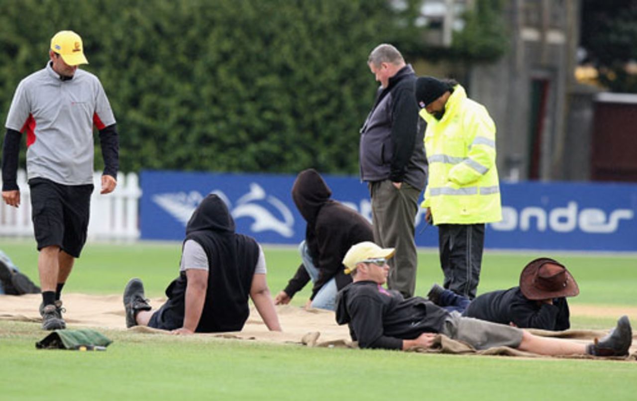 The groundstaff sit on the covers to stop them blowing away, New Zealand v Australia, 1st Test, 4th day, Wellington, March 22, 2010