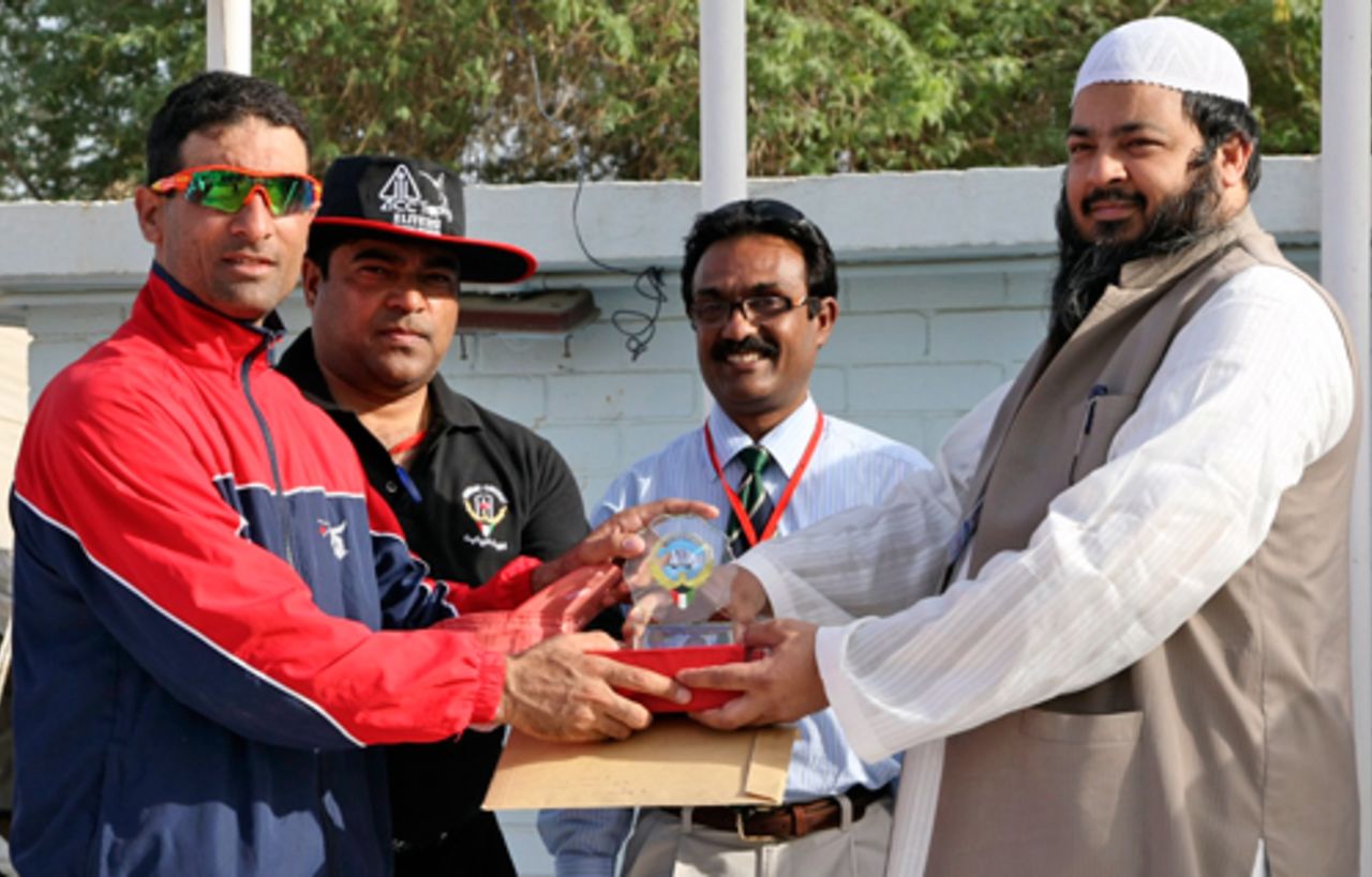 Hong Kong's Hussain Butt receives his Player of the Match award from match officials for his unbeaten 82 against Kuwait at the ACC Trophy Elite 2010