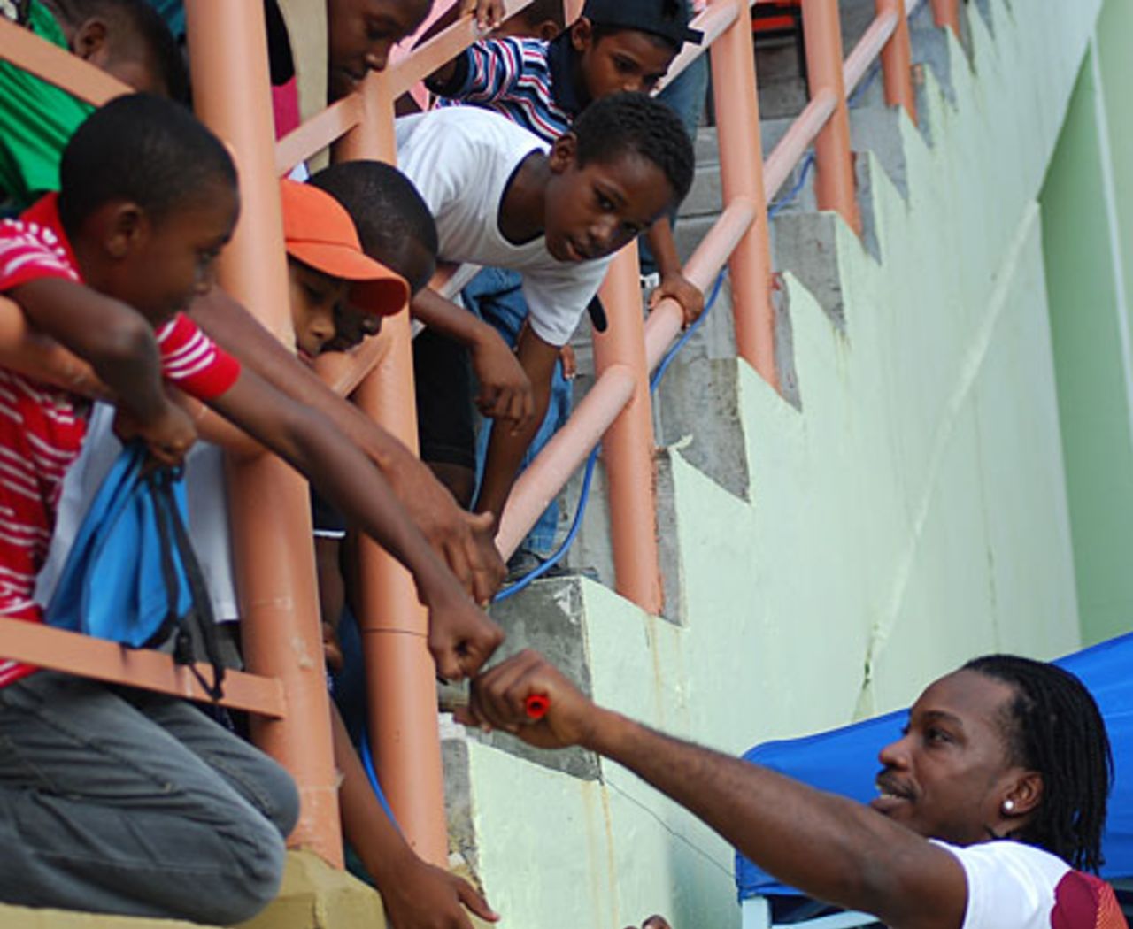 Chris Gayle meets some young fans in the stands during West Indies' training session in Guyana, April 28, 2010
