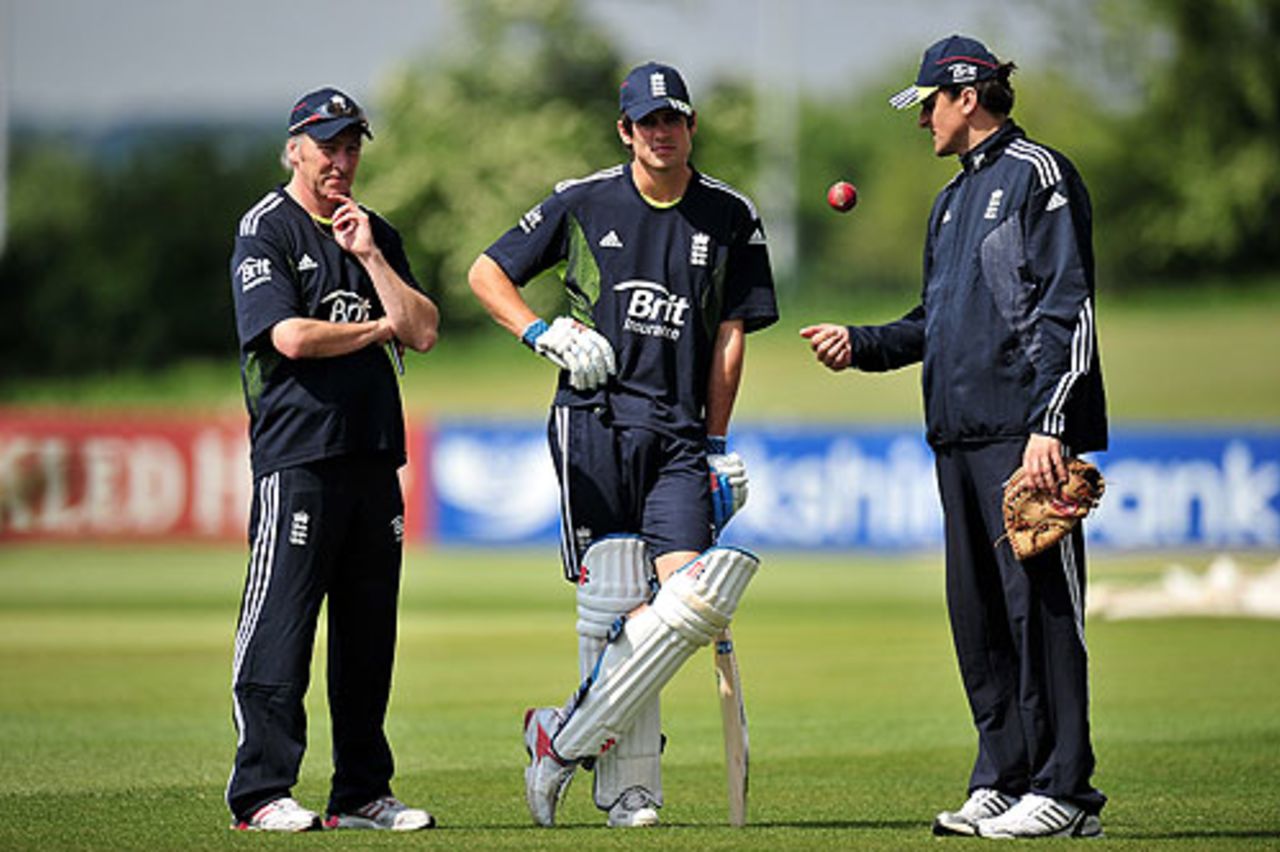 Alastair Cook discusses tactics with the England Lions coaching staff during a training session at Derby, May 18, 2010