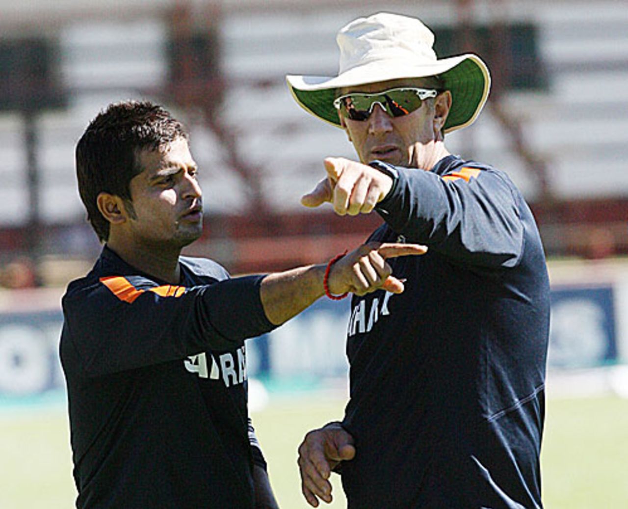Conflicting viewpoints - Suresh Raina in discussion with bowling coach Eric Simons, Bulawayo, May 27, 2010