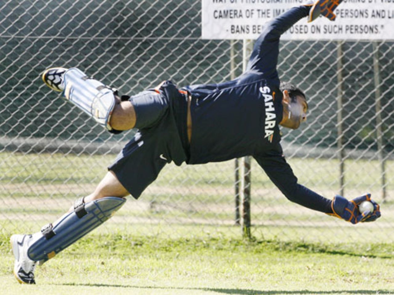 Dinesh Karthik dives to pouch a catch during practice, Harare, June 4, 2010
