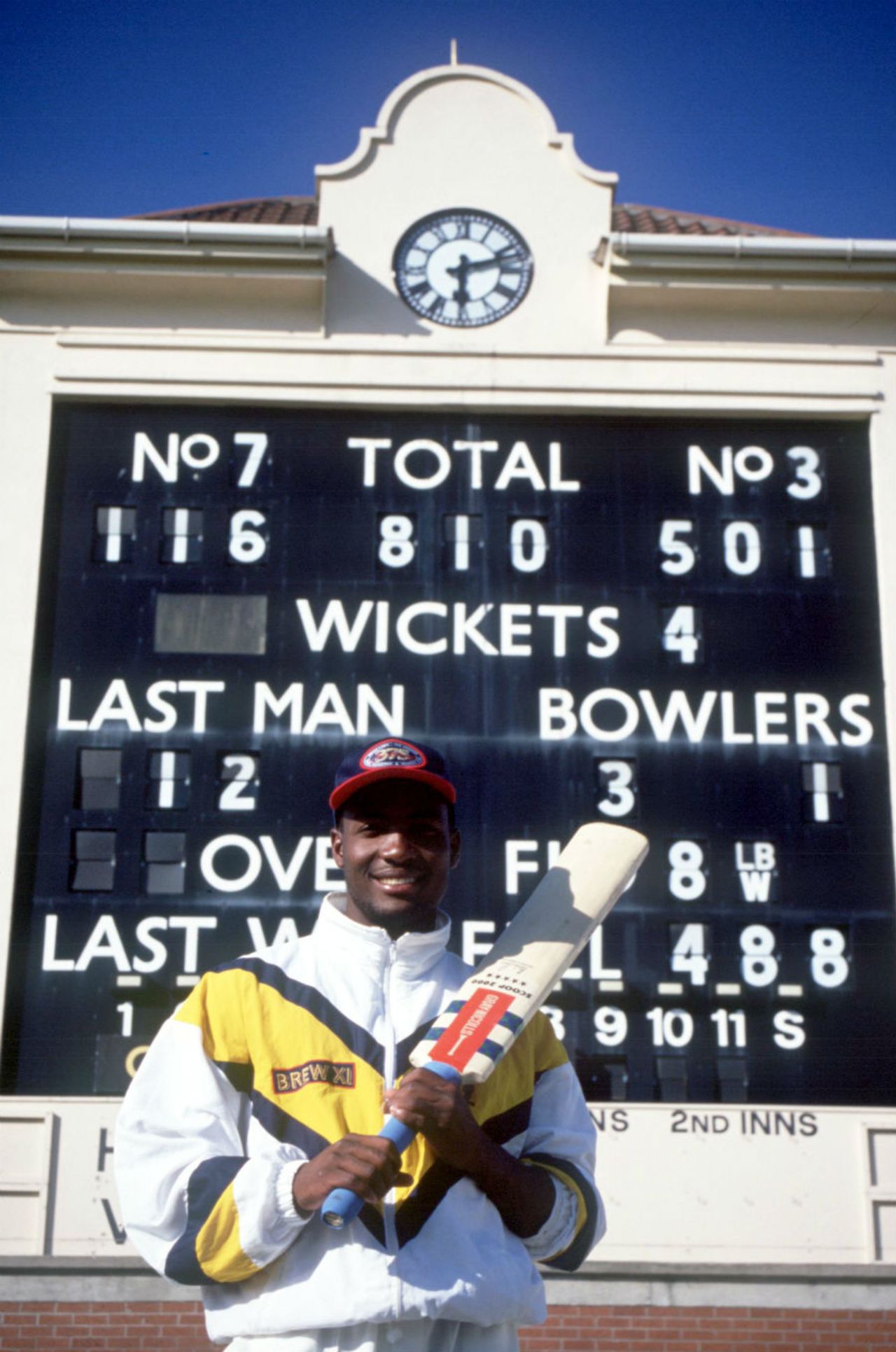 Brian Lara poses next to the scoreboard that shows his record-breaking 501, Warwickshire v Durham, County Championship, Edgbaston, 4th day, June 6, 1994