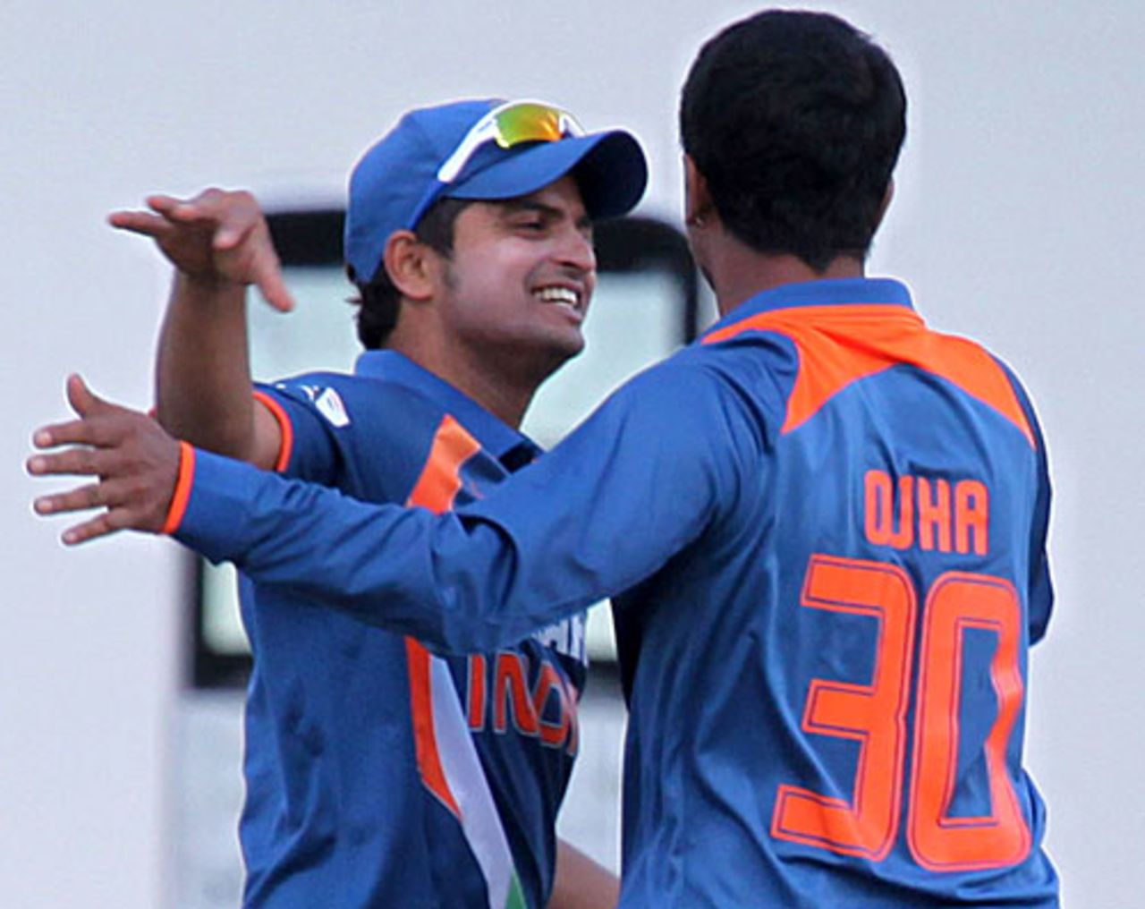 Suresh Raina and Pragyan Ojha celebrate a wicket, Zimbabwe v India, 1st Twenty20, Harare, June 12, 2010